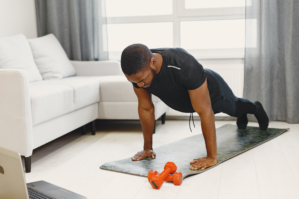 Person doing a bodyweight squat in a bright living room